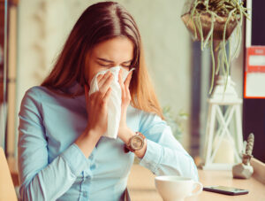 jeune femme qui se mouche à cause des allergies saisonnières